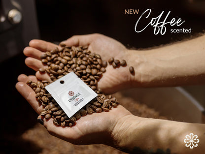 Hands holding coffee beans and essence ring