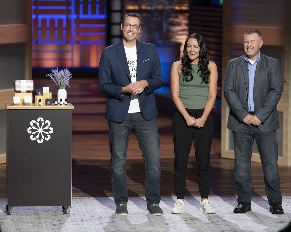 Judah, Tami, and Mike pitching essence on the Shark Tank stage